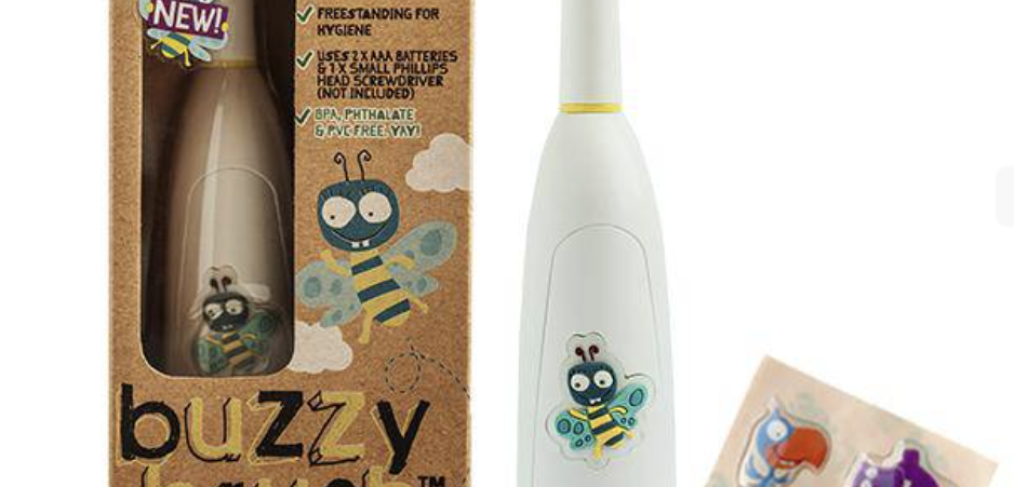 Buzzy brush electrical toothbrush in a cardboard box with another unpackaged white matching toothbrush to the right