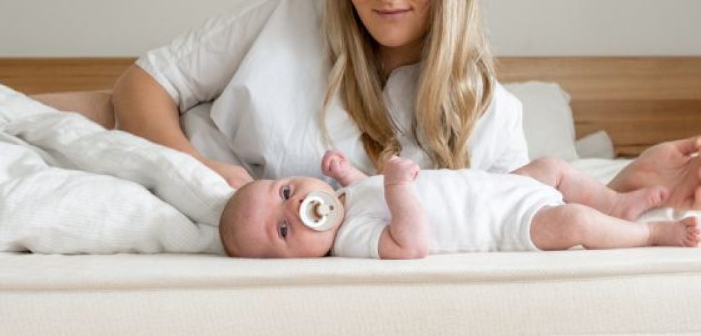 Peacelily mattress. Mother and infant resting in bed