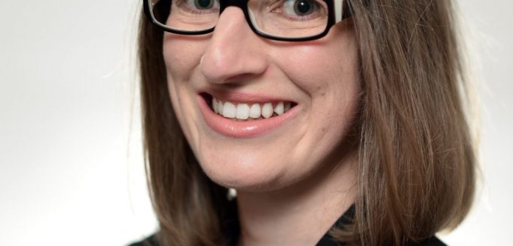 Jacinta Grima - woman wearing business attire, glasses, smiling