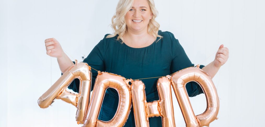 woman holding ADHD balloons