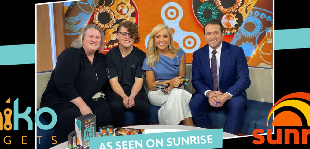 kaiko fidgets owners sitting on a couch with sunrise show hosts