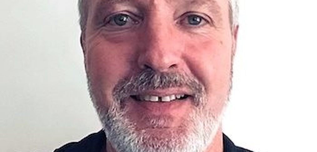 Brisbane City Psychologist Gerhard Venter - Man wearing navy blue polo shirt, smiling